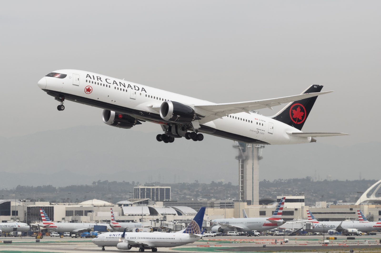 a large white airplane taking off