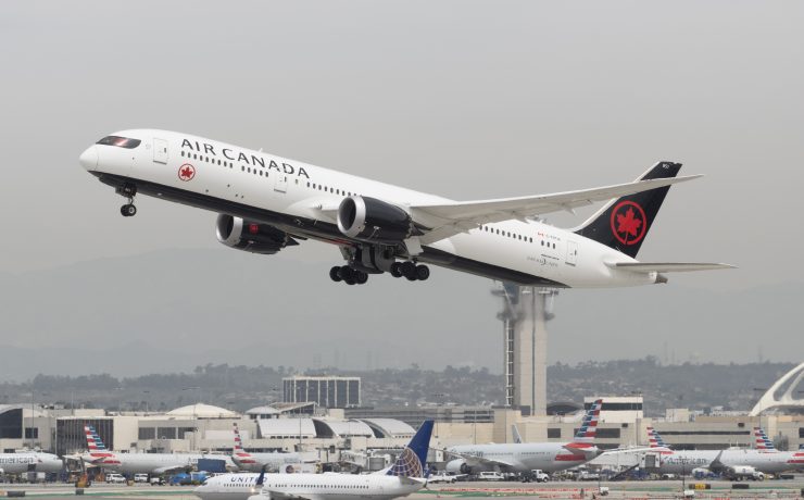 a large white airplane taking off