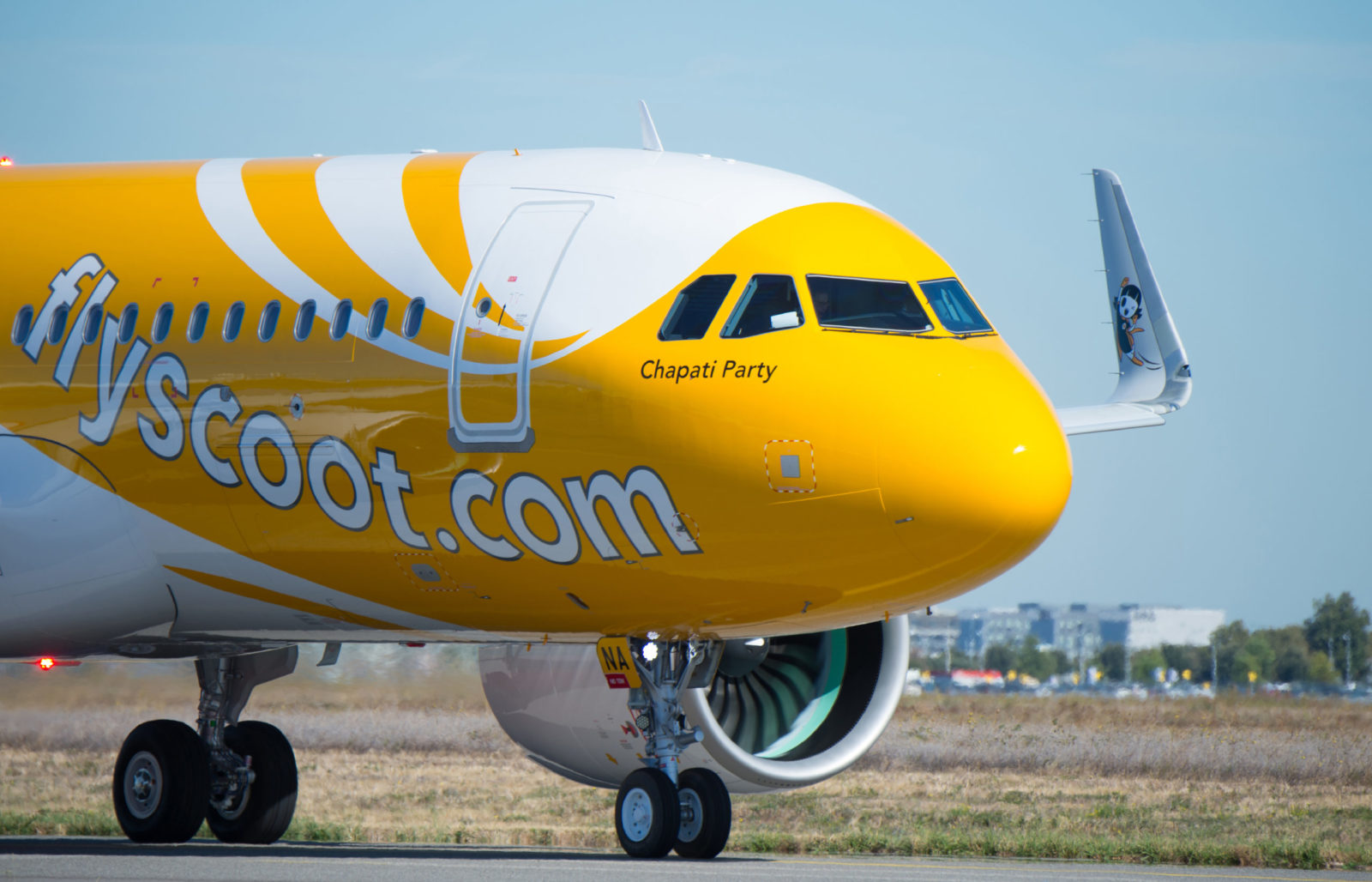 a yellow and white airplane on a runway