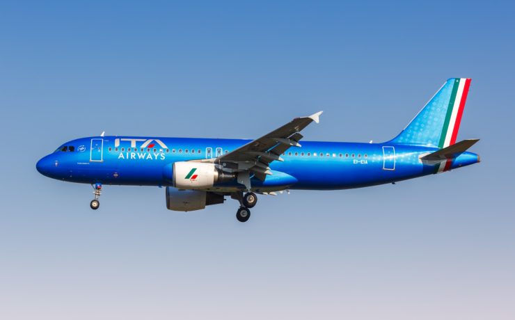 a blue airplane in the sky