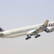 a large white airplane flying in the sky