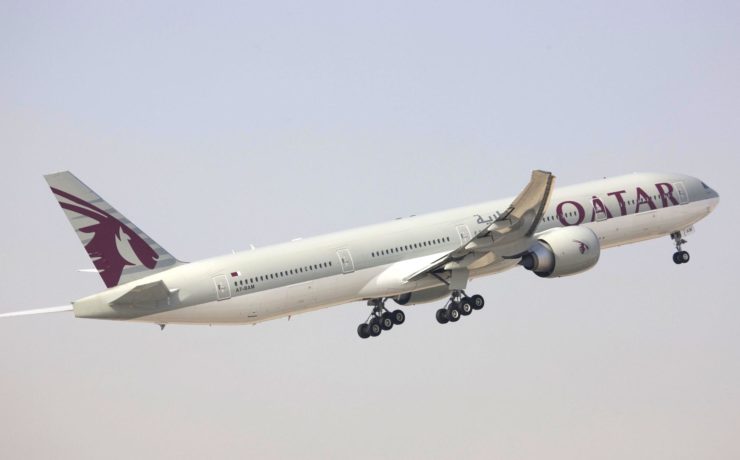a large white airplane flying in the sky