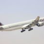 a large white airplane flying in the sky