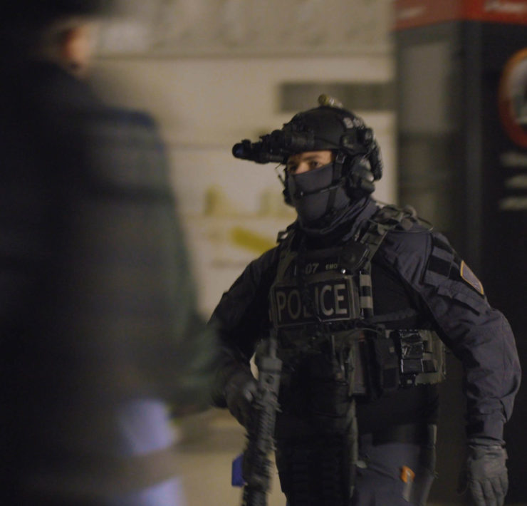 a person in uniform with a gun