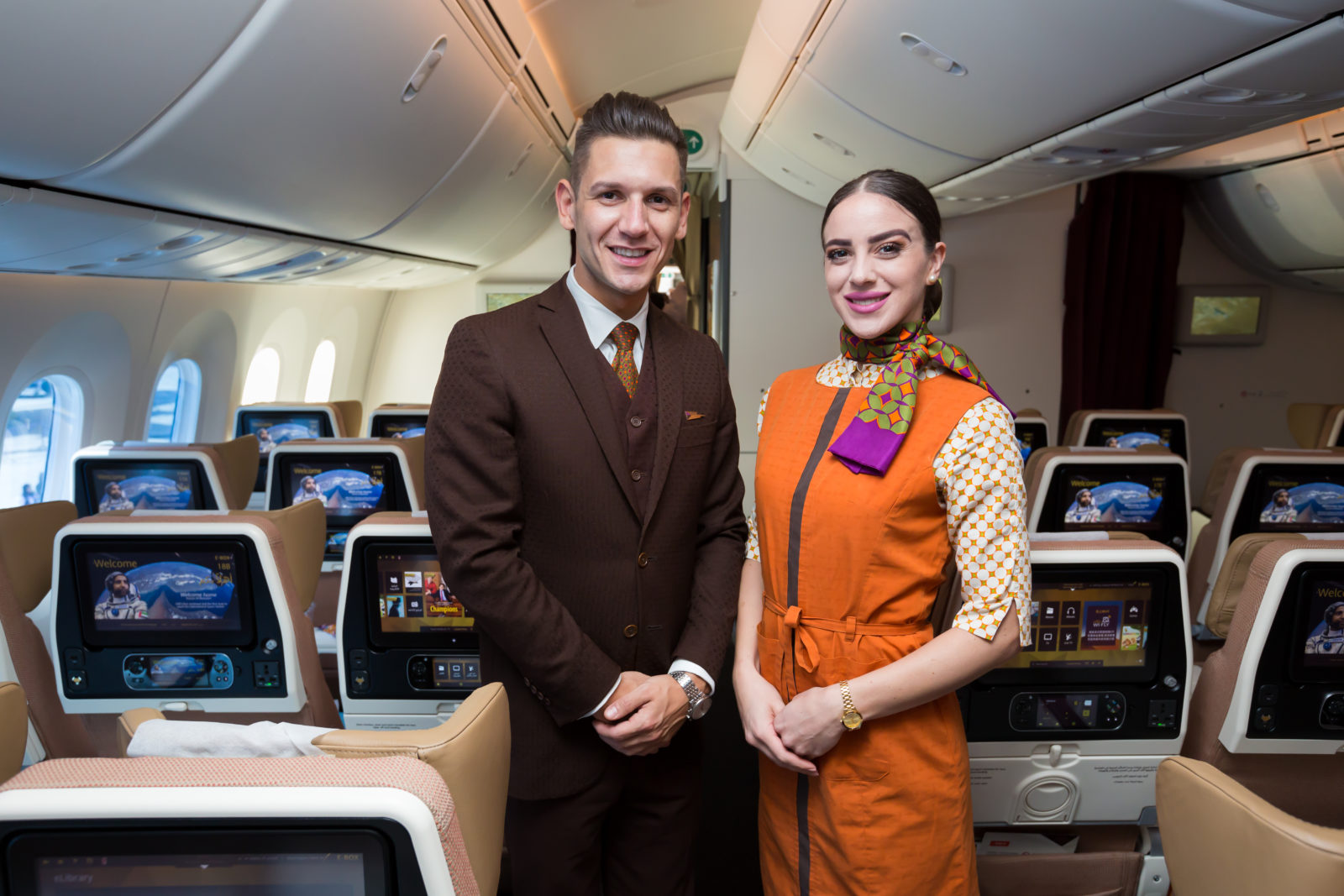 a man and woman standing in an airplane