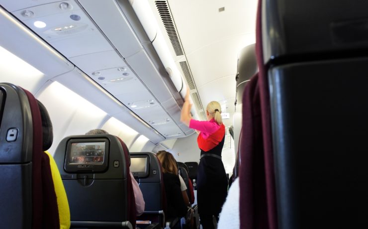 a woman standing in an airplane