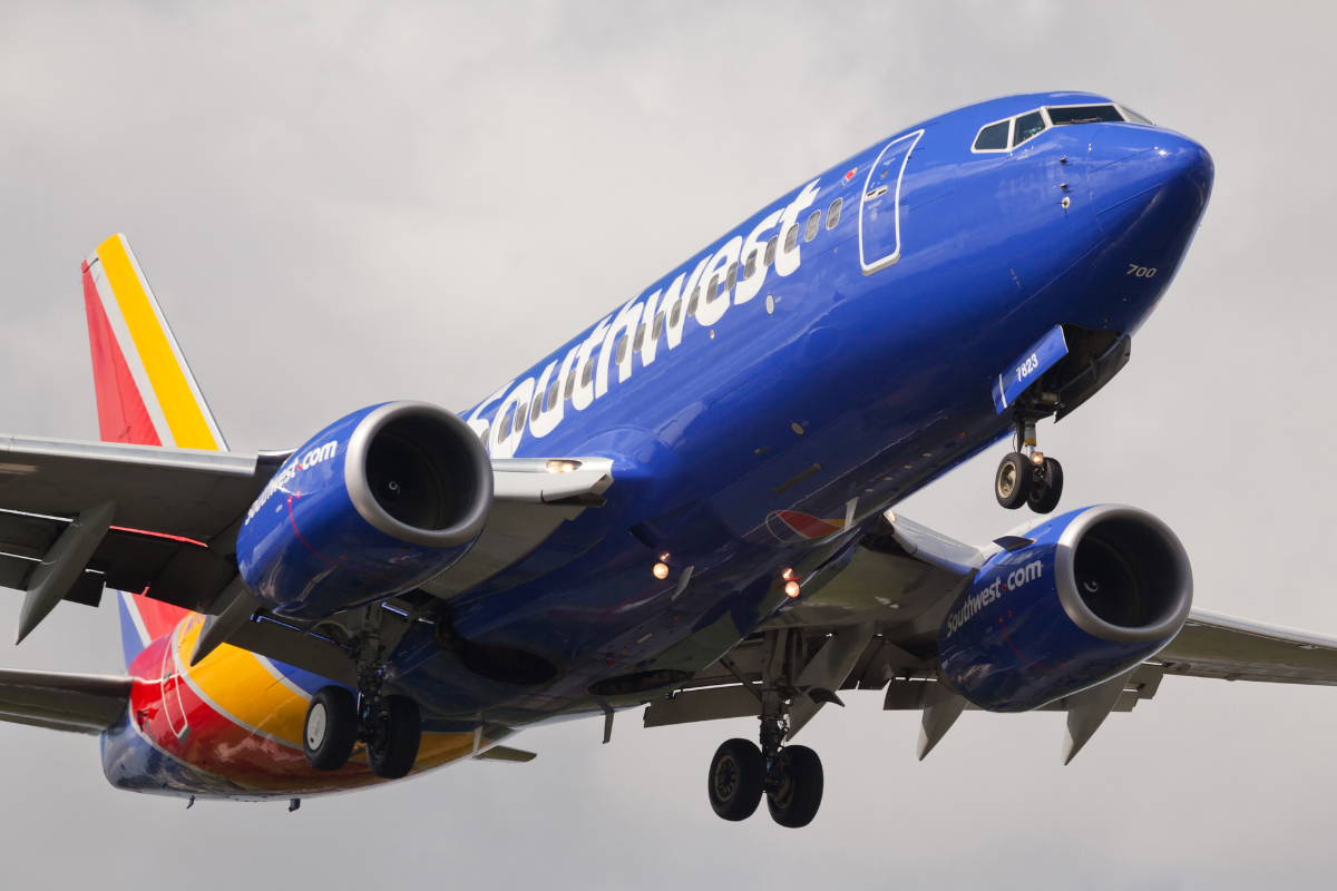 a blue airplane in the air