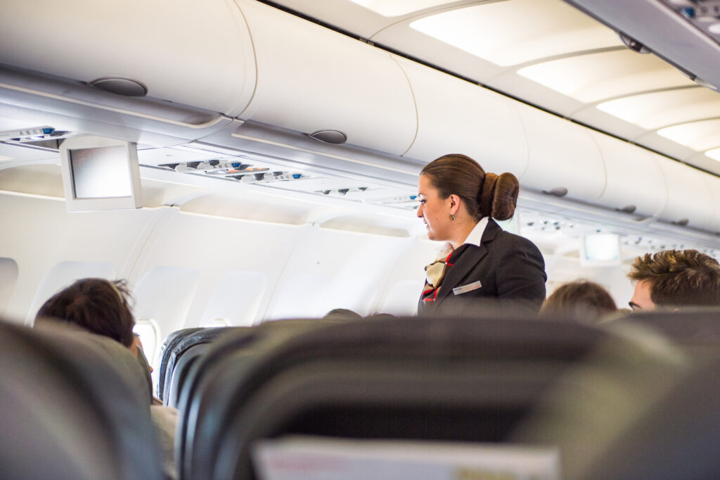 a woman in a suit on an airplane