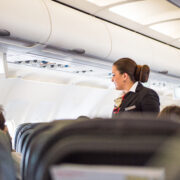 a woman in a suit on an airplane