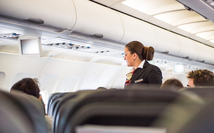 a woman in a suit on an airplane