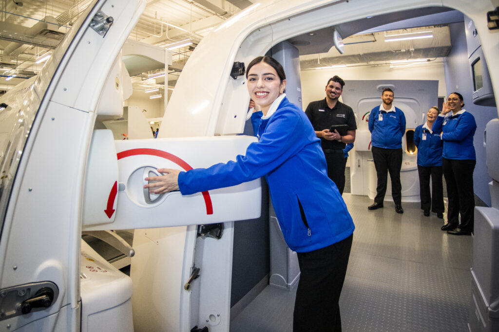 a woman in a blue jacket holding a machine