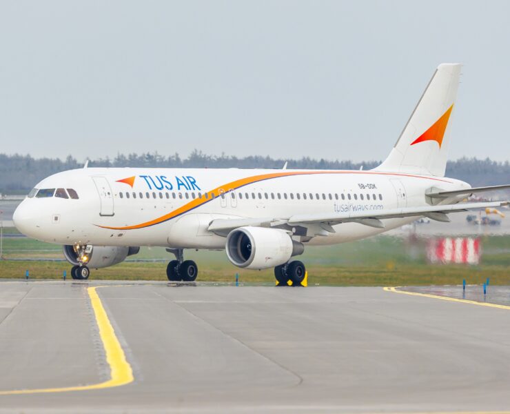 a white airplane on a runway