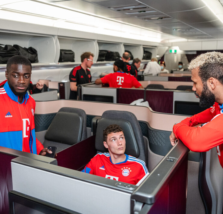 a group of men in a room with chairs and tables