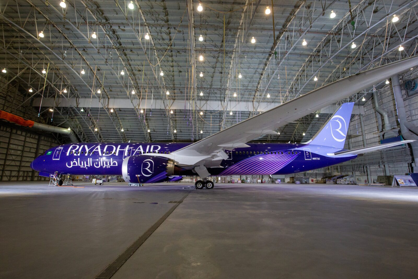 a blue and white airplane in a hangar