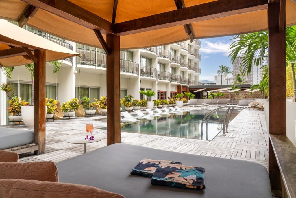 a pool with a deck and chairs