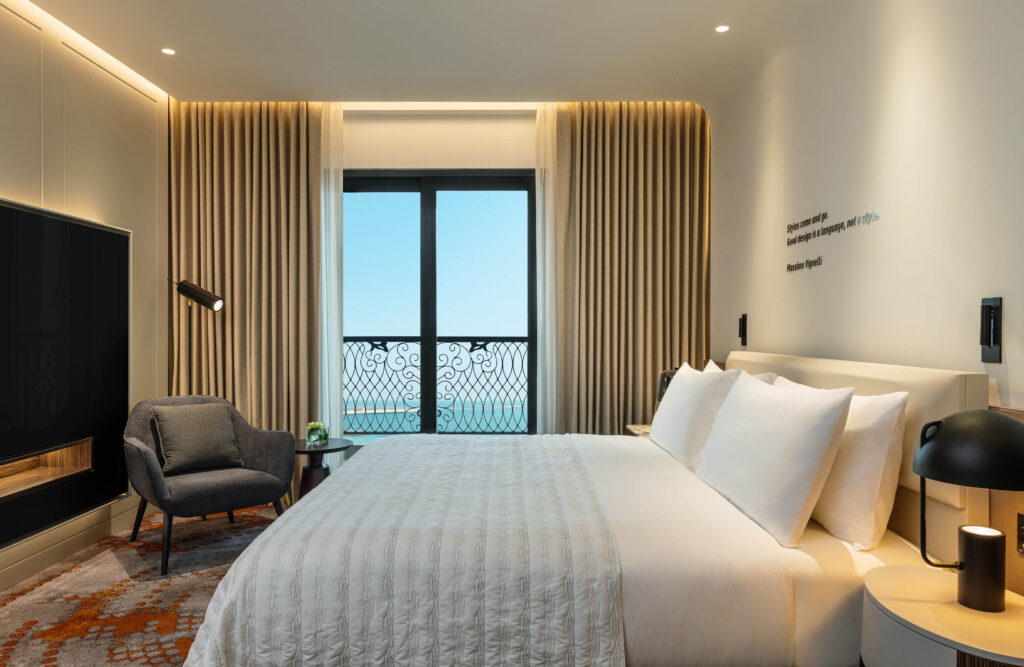a bedroom with a bed and a chair