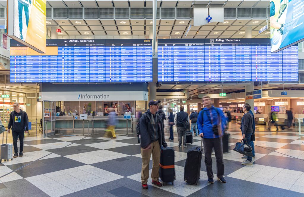 people in an airport with luggage