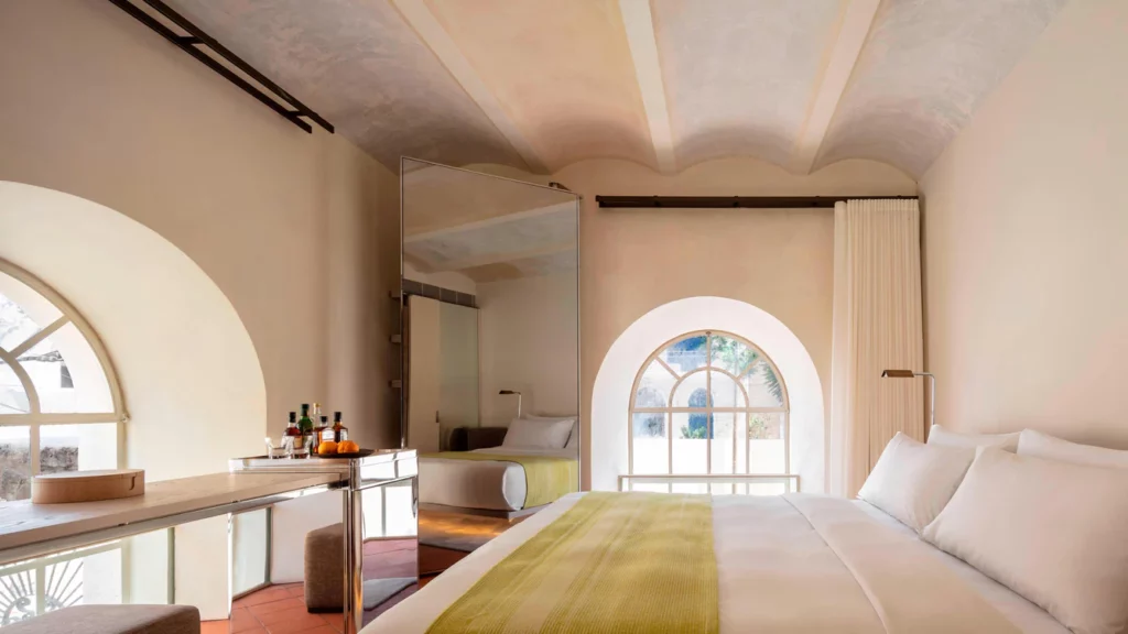 a room with a bed and a mirror