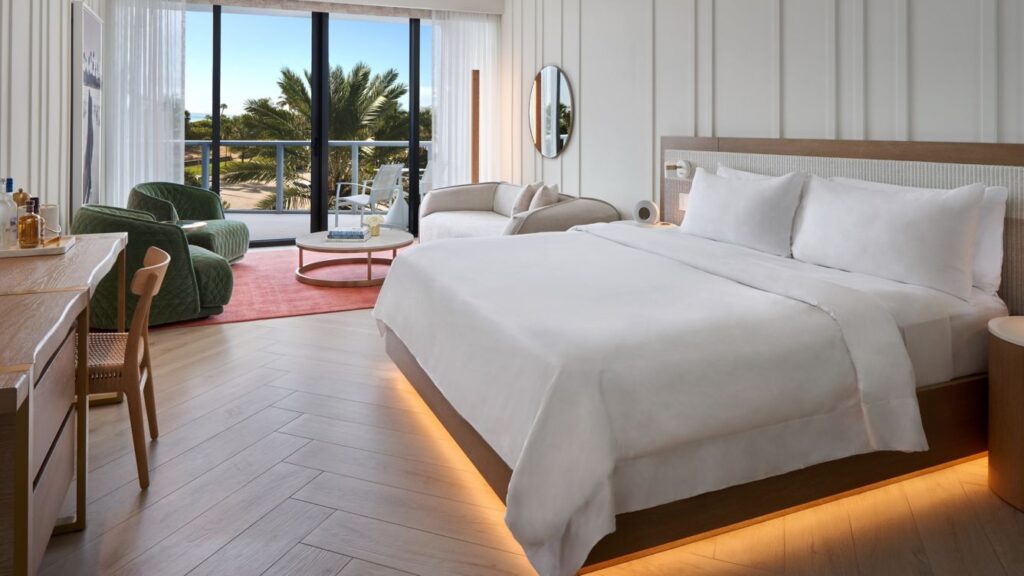 a room with a bed and chairs