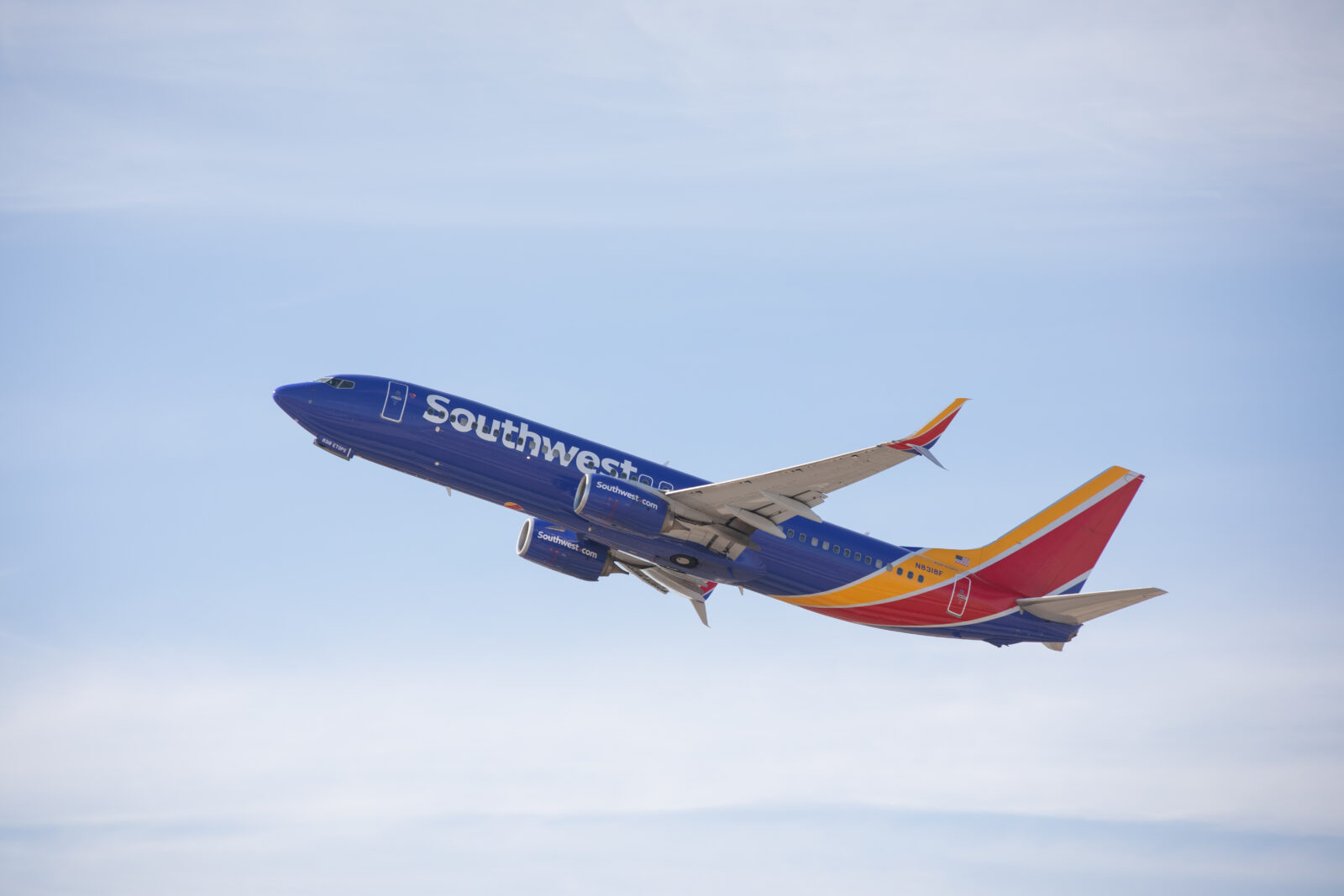 a blue and red airplane in the sky