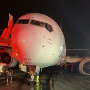 a large white airplane on a runway at night