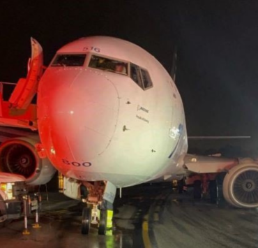 a large white airplane on a runway at night