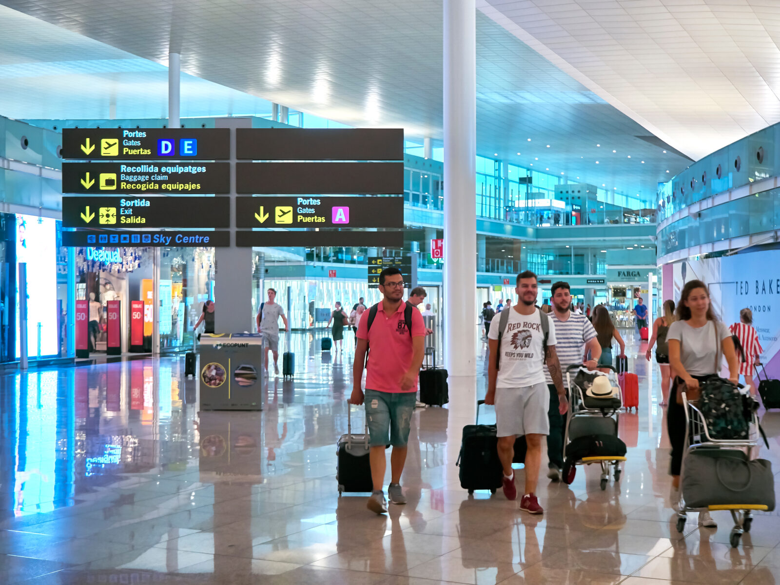 a group of people with luggage in a airport