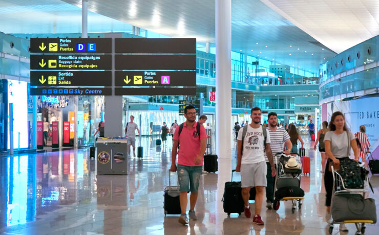 a group of people with luggage in a airport
