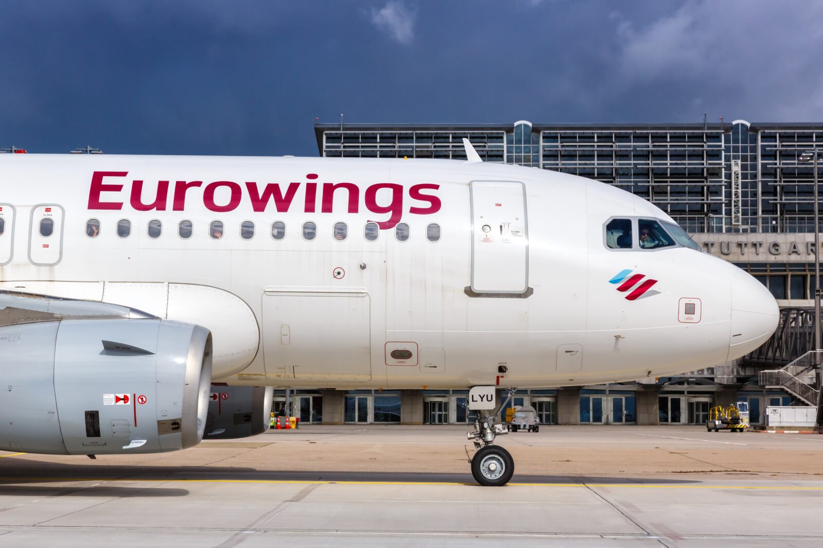 a white airplane with red writing on it