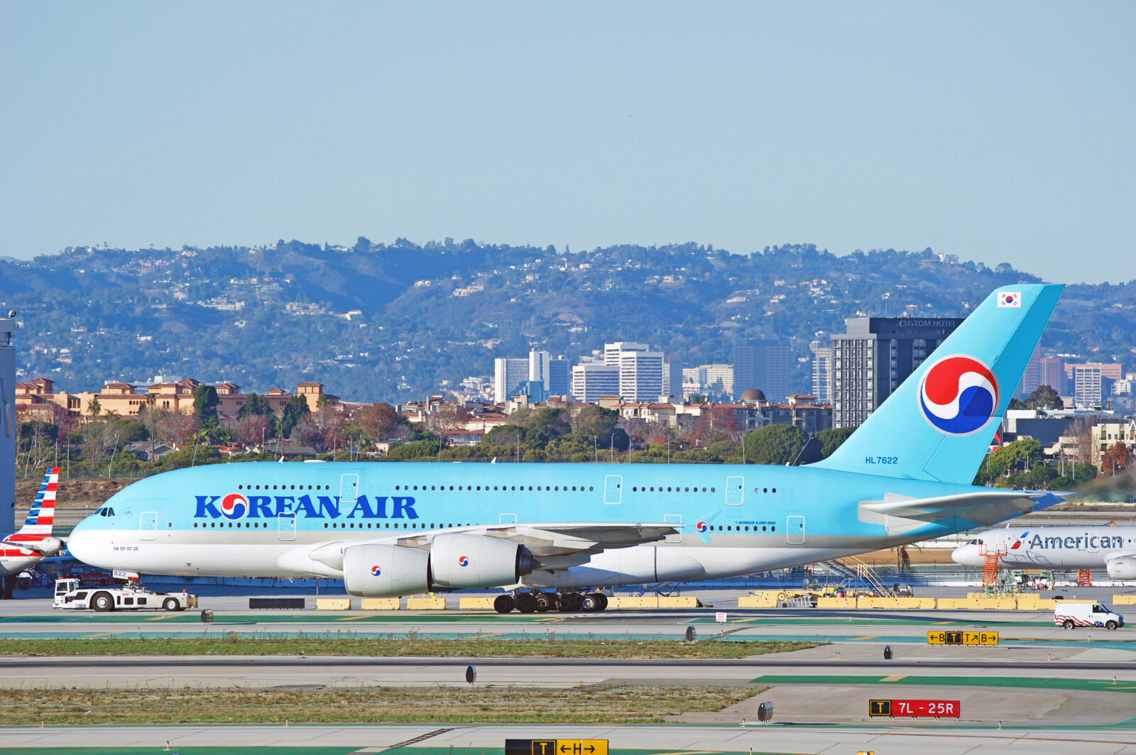 a blue and white airplane on a runway