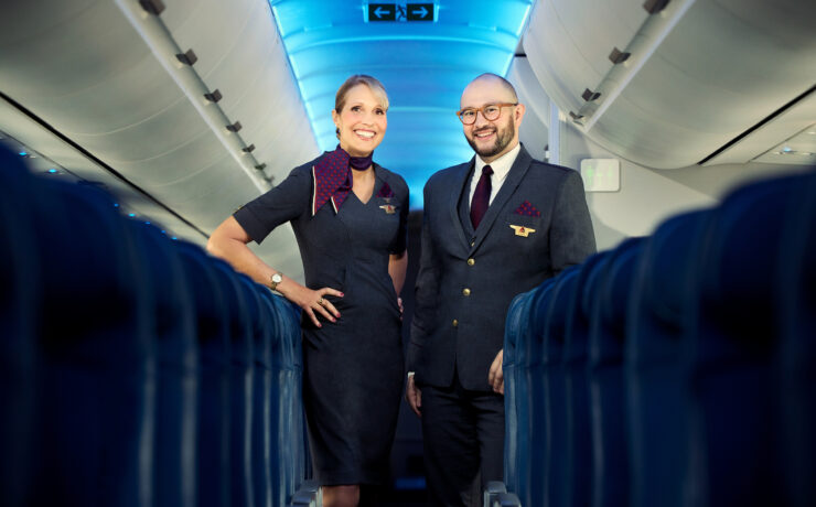 a man and woman standing in an airplane