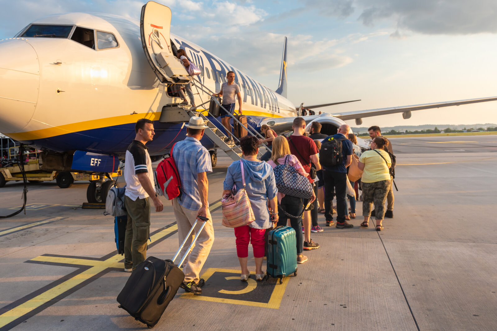 a group of people boarding an airplane