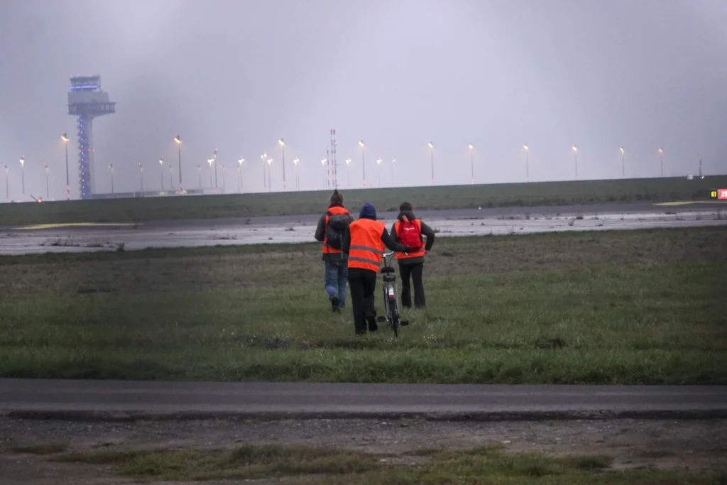 a group of people walking on a bike in a field