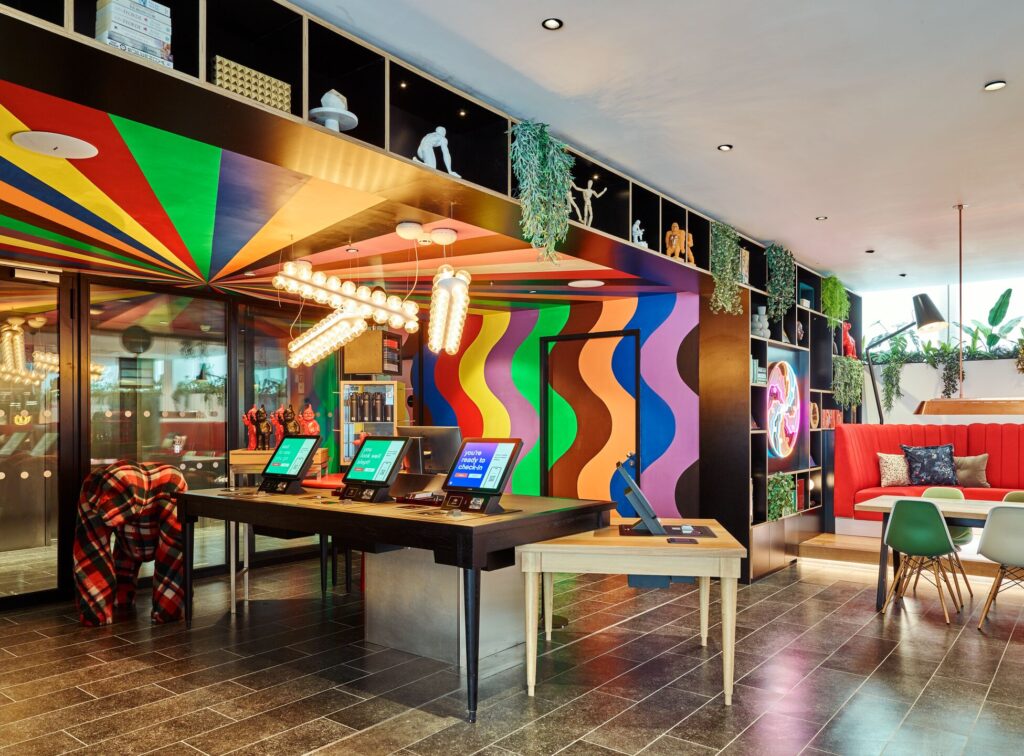 a room with colorful walls and a table with computers