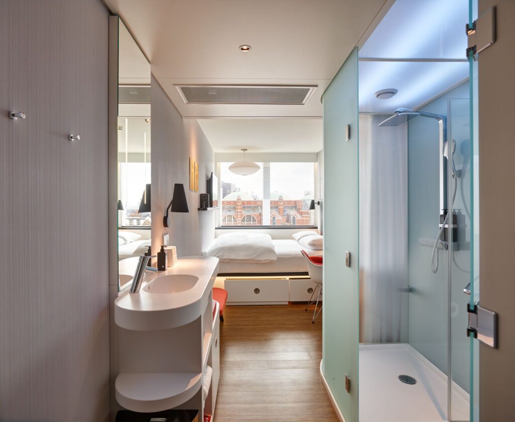 a bathroom with a shower and a bed