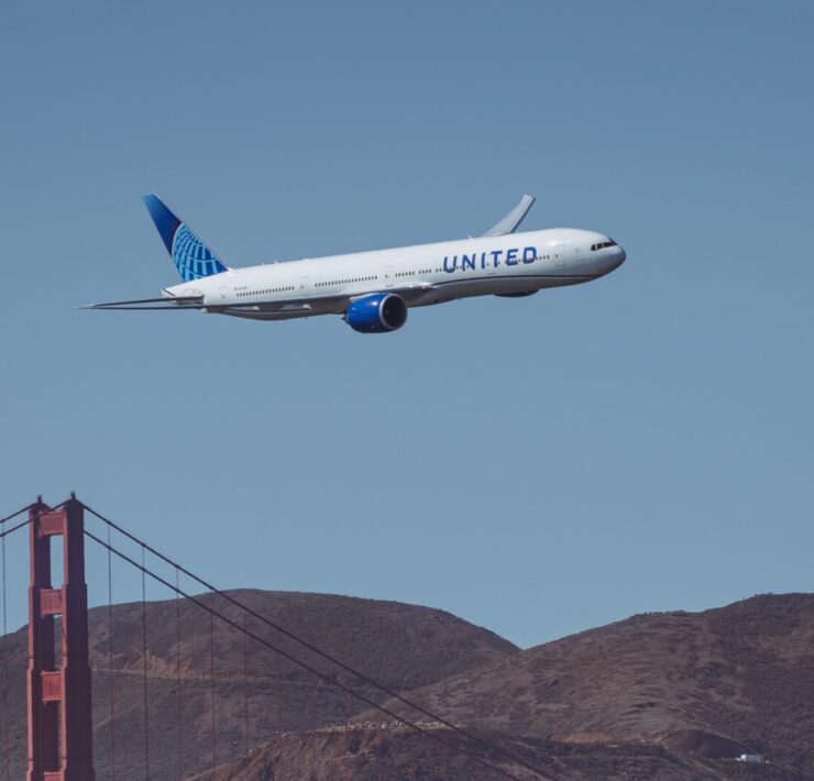 a plane flying over a bridge