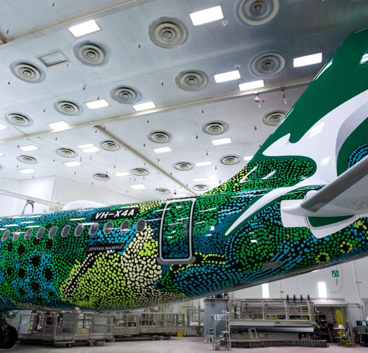 a green and white airplane in a swinger