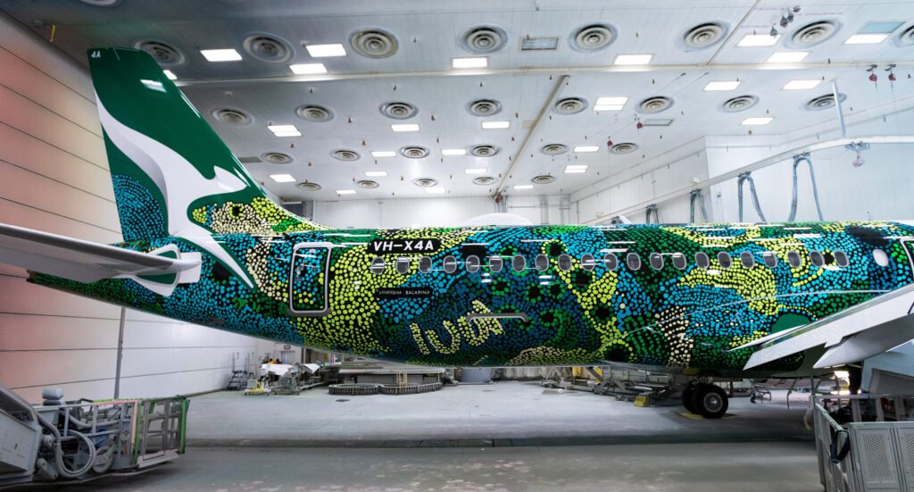 a colorful airplane in a hangar