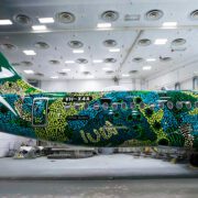 a colorful airplane in a hangar