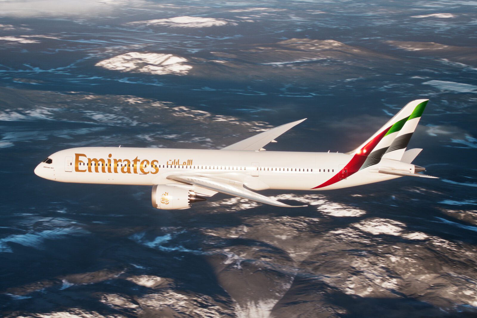 a white airplane flying over a snowy landscape