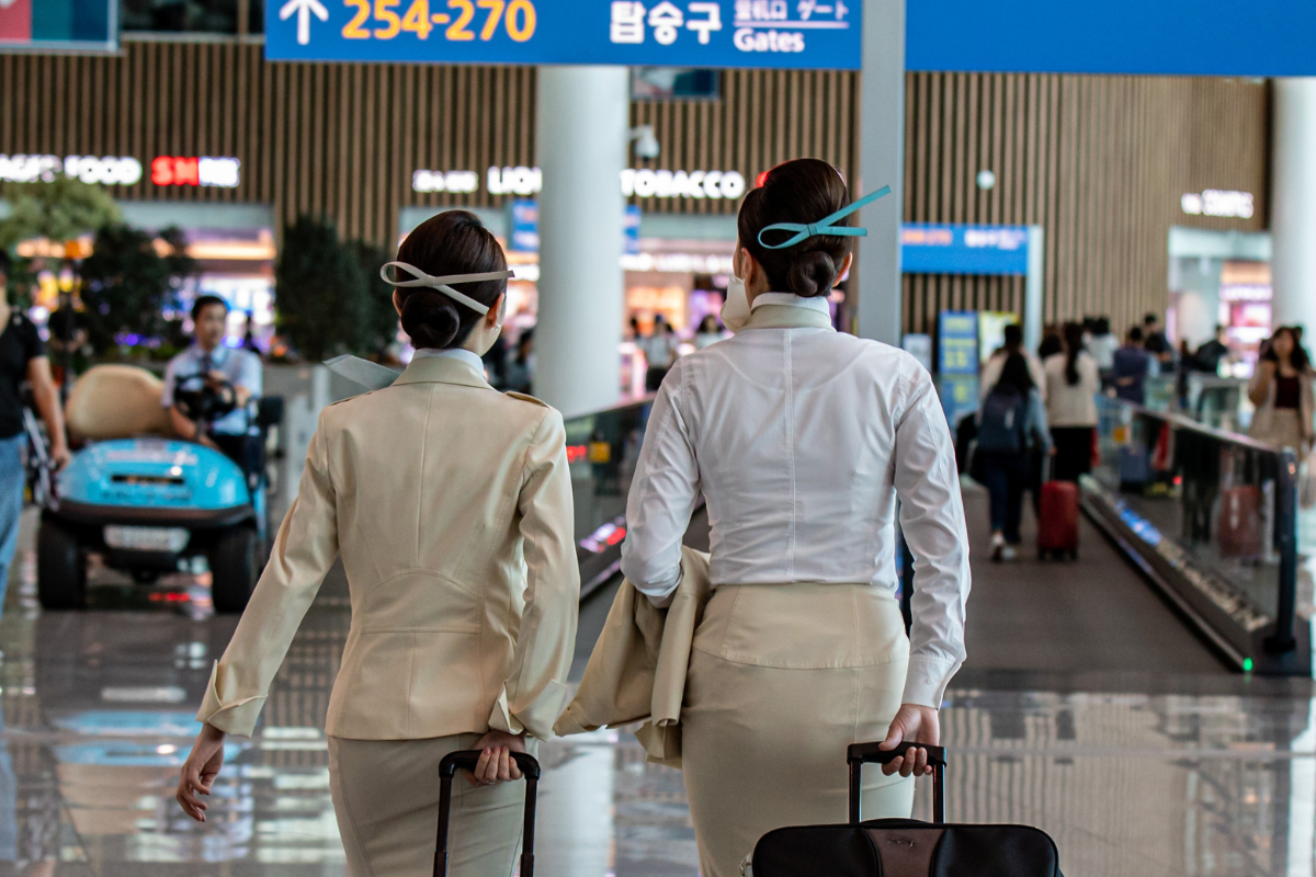 two women in uniform with luggage