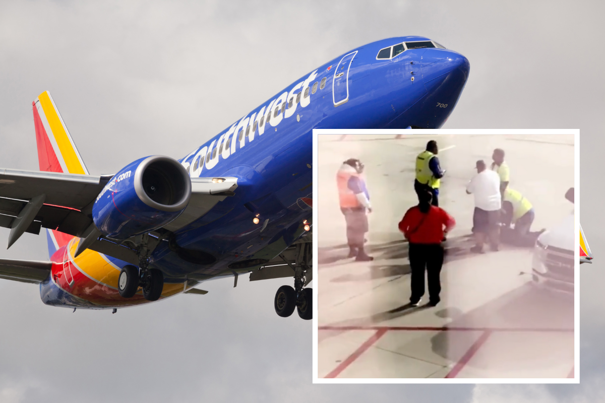 a blue airplane with people standing in the air