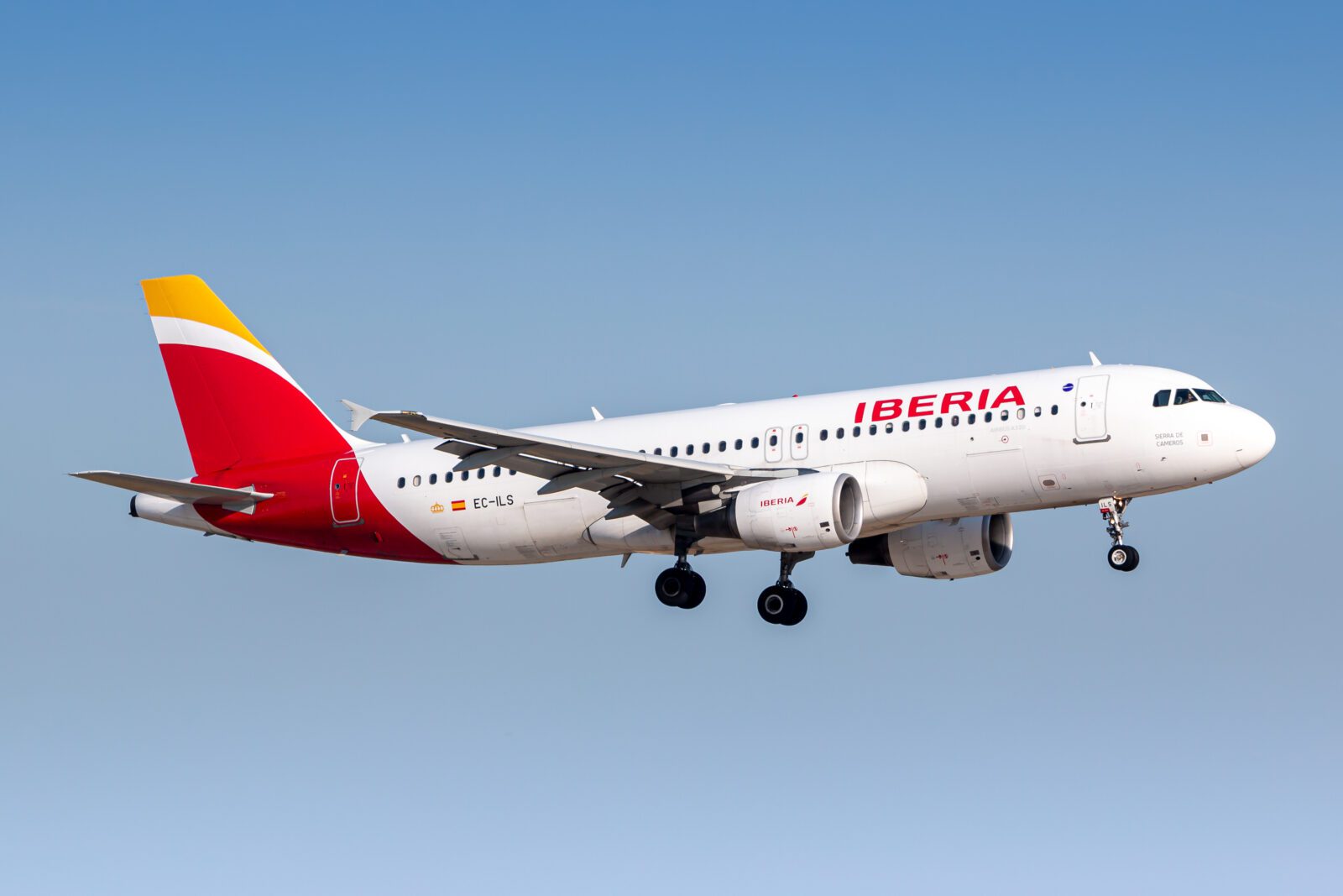 a white and red airplane flying in the sky