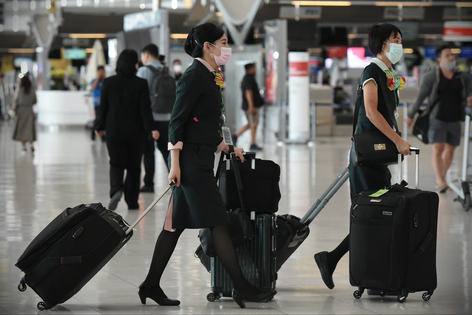a group of women with luggage in an airport