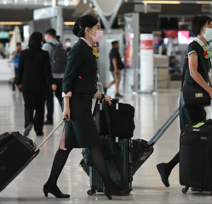 a group of women with luggage in an airport