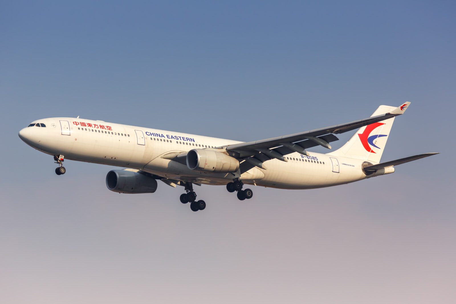 a white airplane flying in the sky