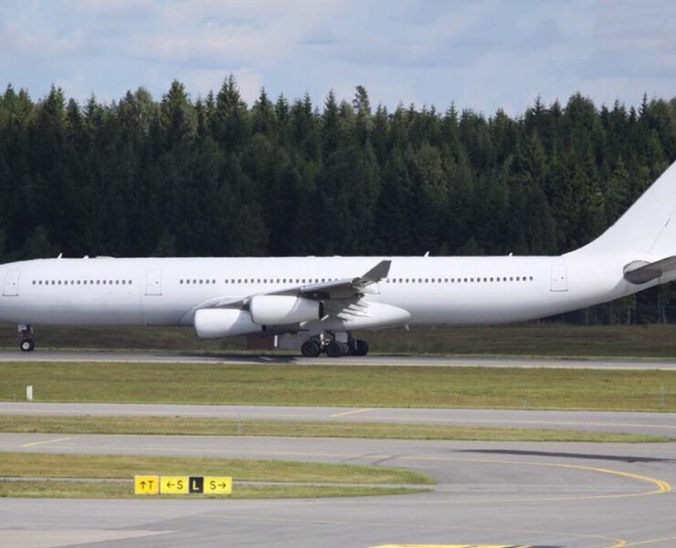 a large white airplane on a runway