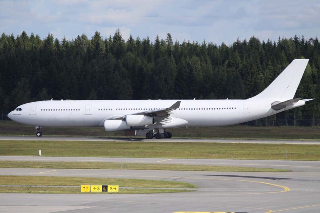 a large white airplane on a runway