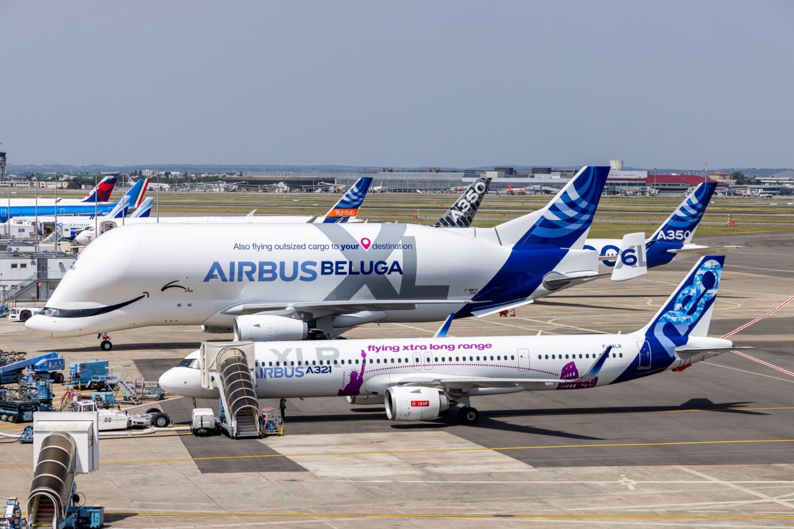 a group of airplanes parked on a runway