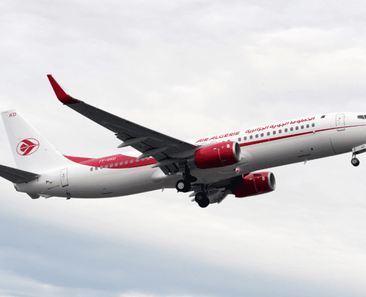 a white and red airplane in the sky